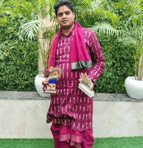Pandit Shubham Sharma holding awards